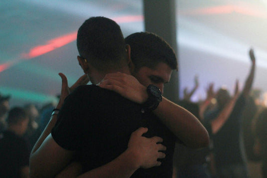 Two men hugging to show compassion and practice empathy